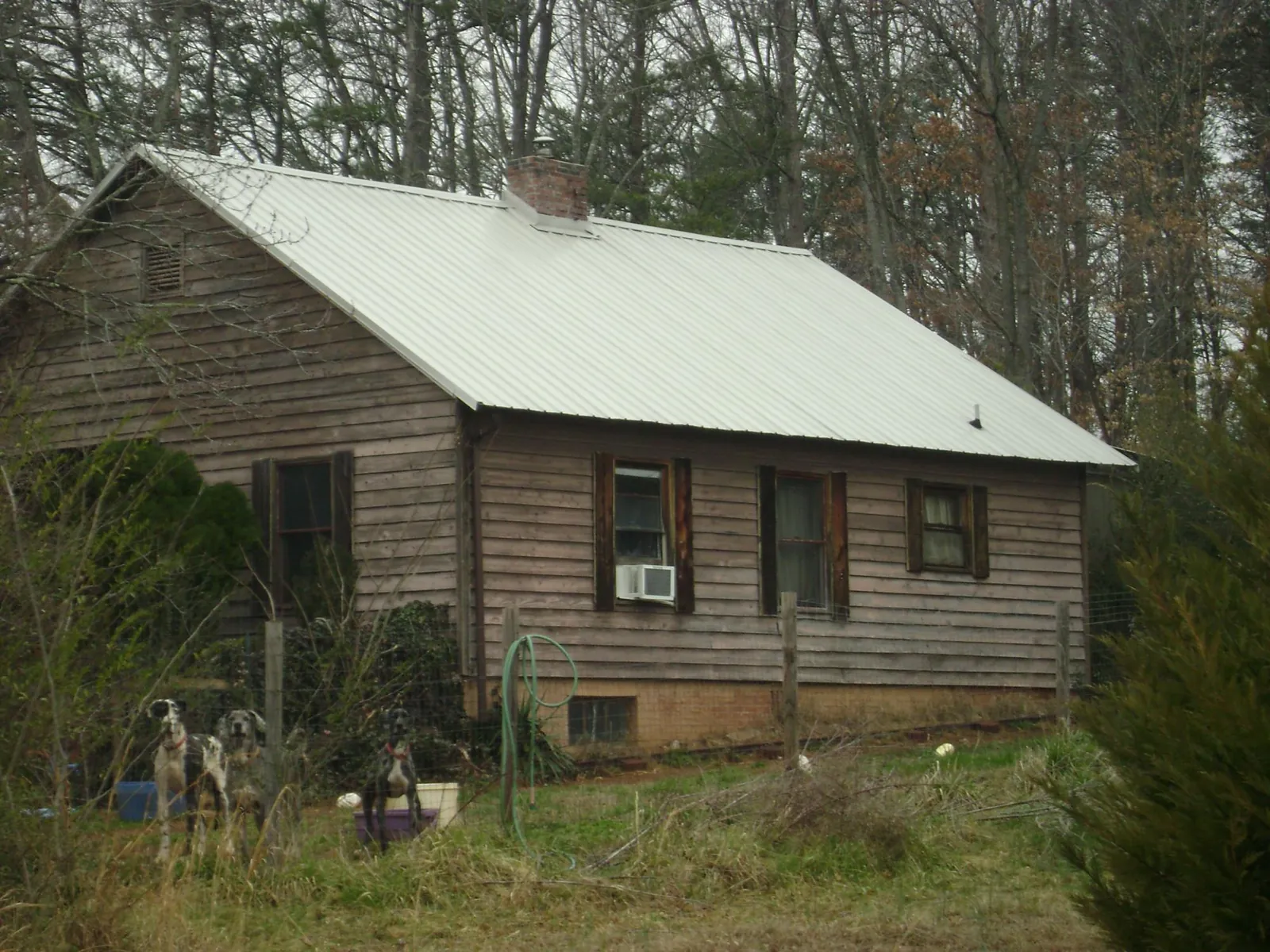 White metal roof on an old wood sided farmhouse, from a Metal Roof Installation job in Grimsley